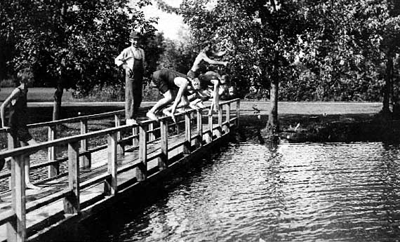 Image of Boys diving off a bridge
