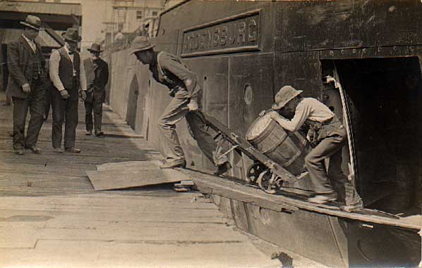 Image of Men hauling a barrel